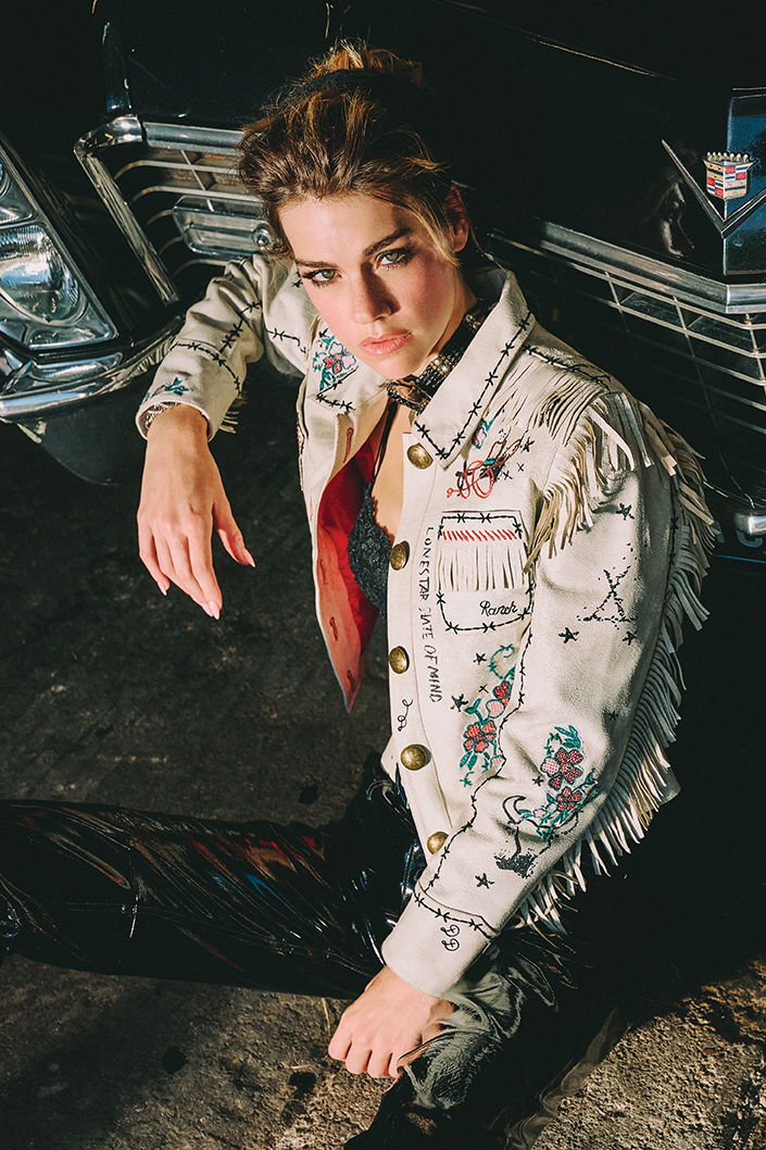 Lozzie wearing the Wagon Train jacket with a Mummy's Bundle necklace.