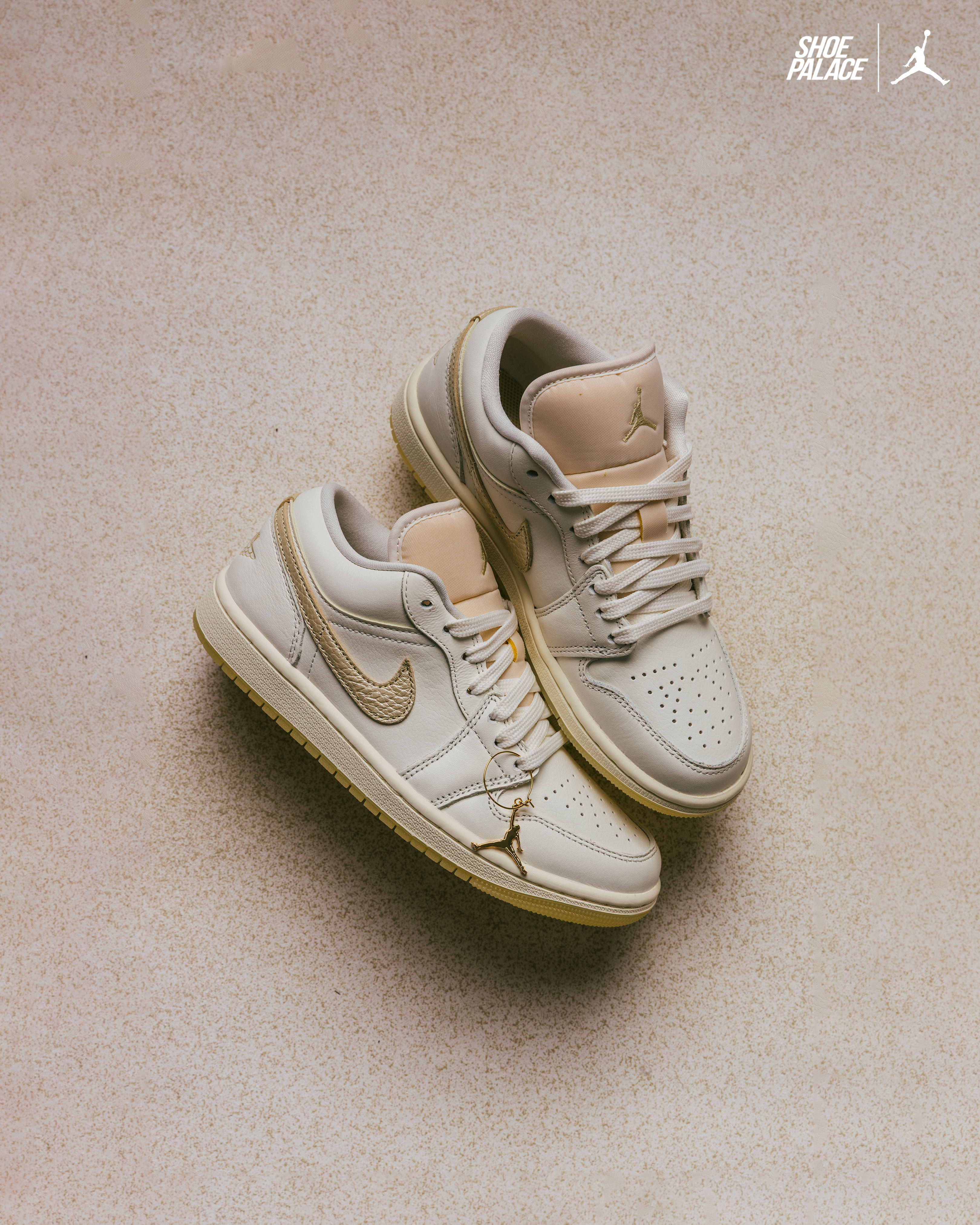 A pair of beige Nike Air Jordan sneakers on a neutral background.