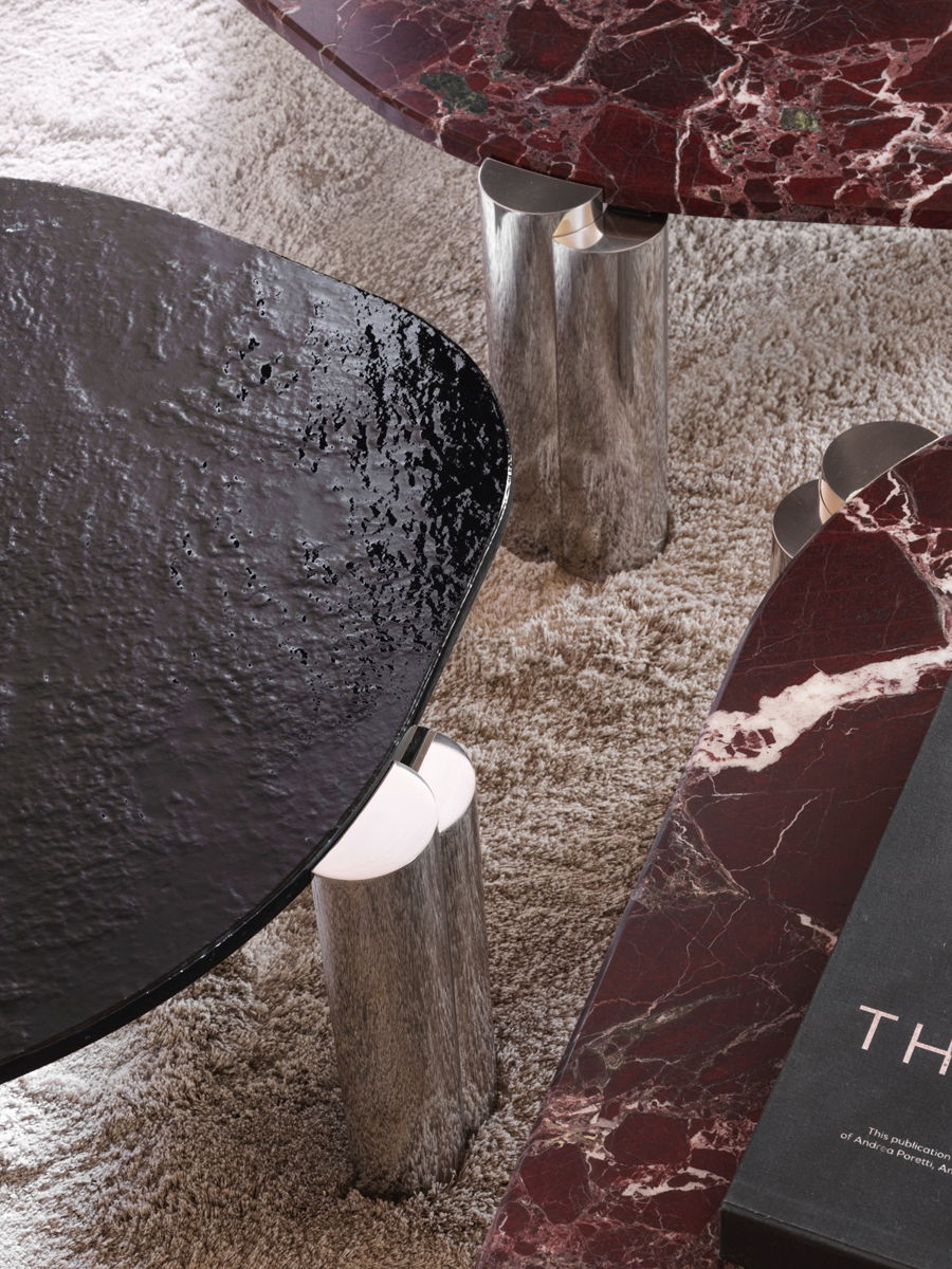 A close-up of modern tables with marble tops and metallic legs.
