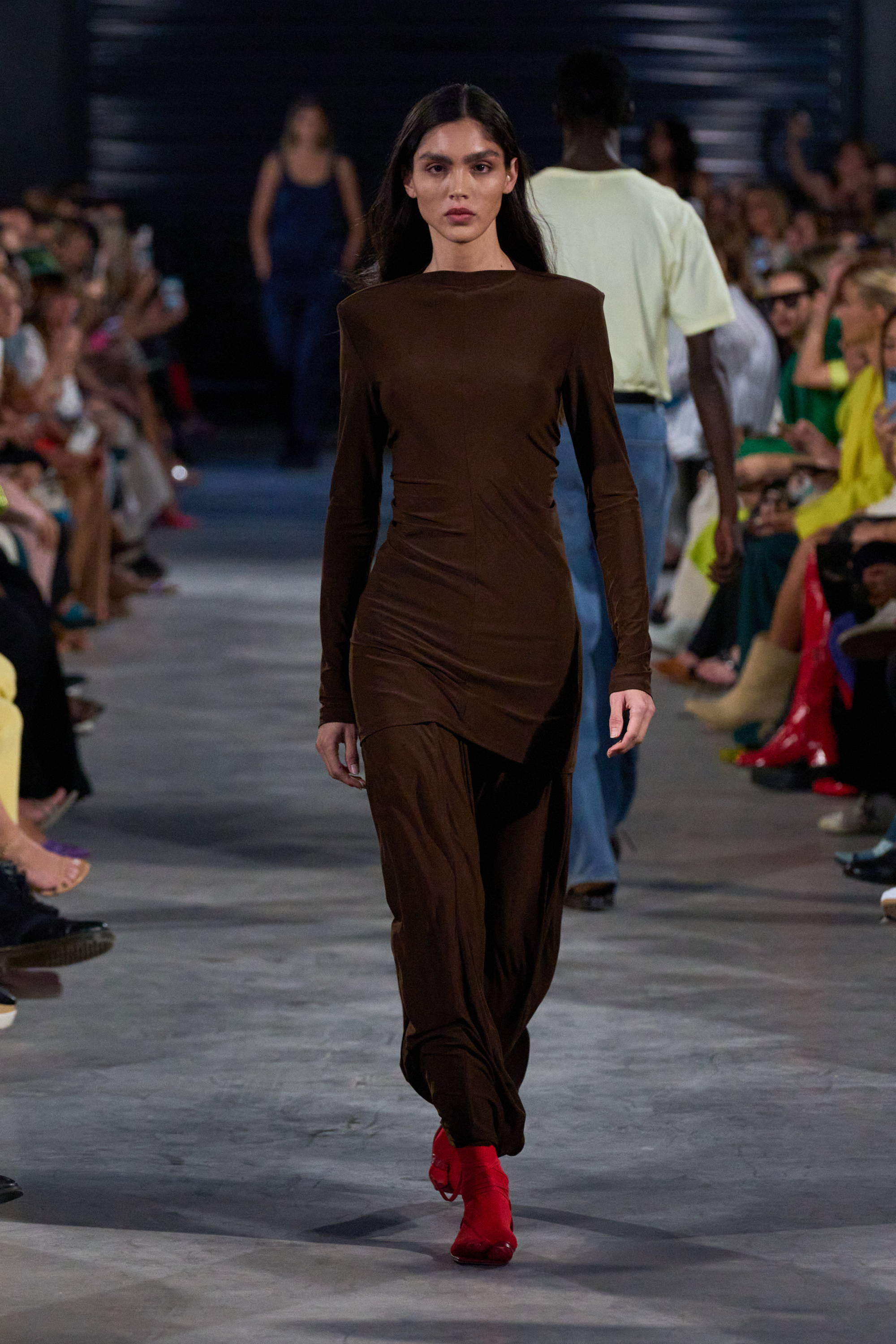 Model on a runway wearing tunic and maxi skirt