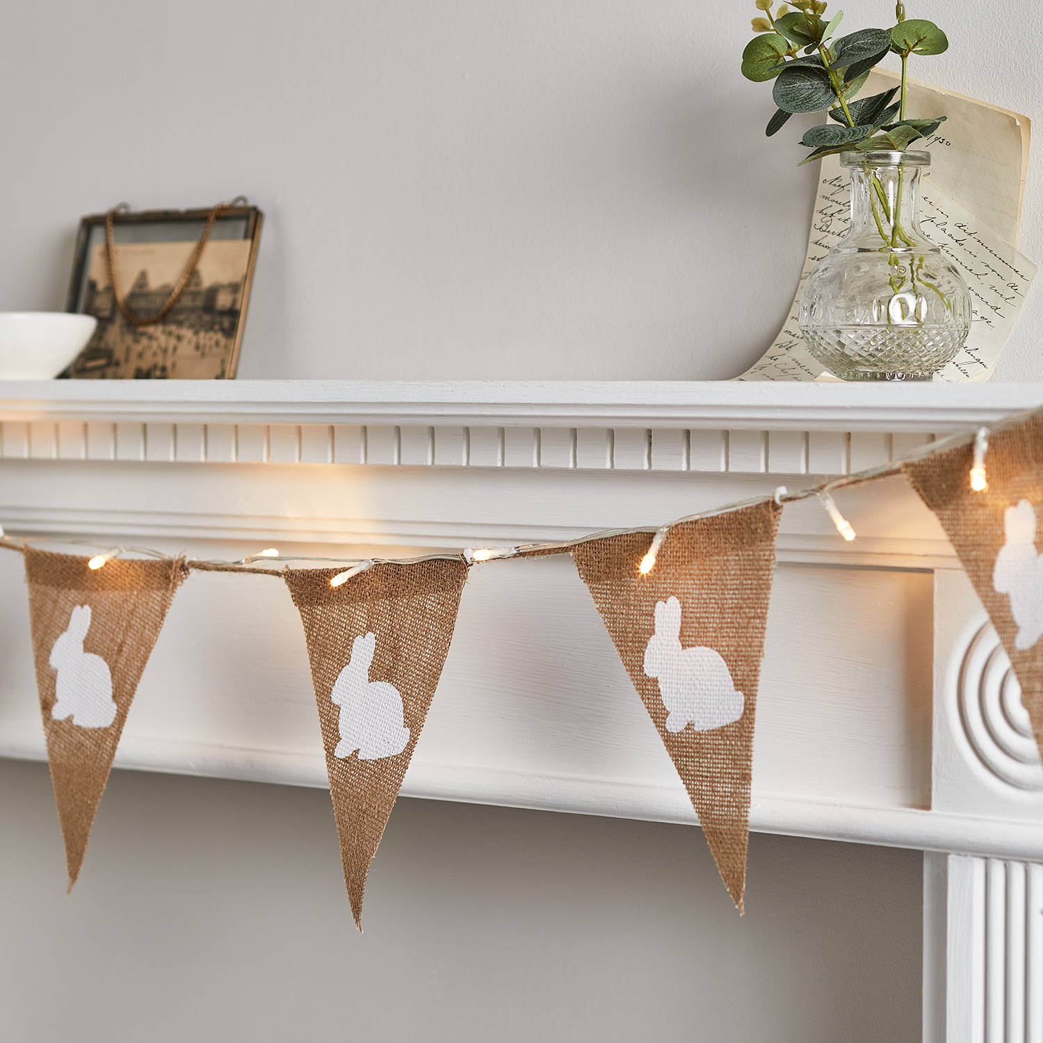Bunny Easter bunting illuminated and displayed across mantel