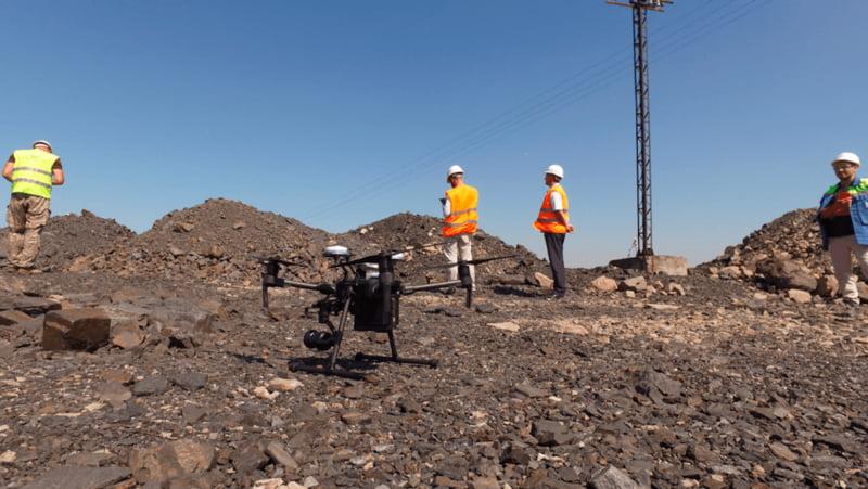 DJI Enterprise drone and mining personnel preparing for an aerial survey at an open-pit mine