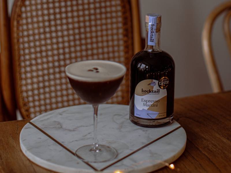 Espresso Martini cocktail and bottle on a marble tray