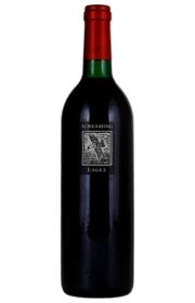 A bottle of red wine with a green and red label.