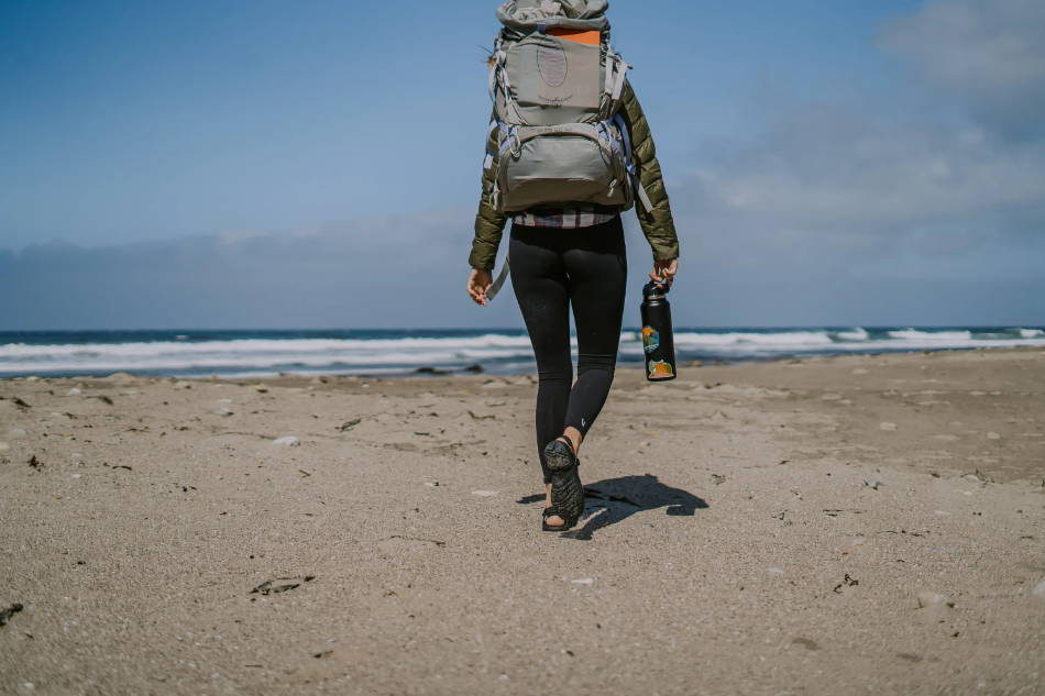 woman wearing walking sandals on the beach of America