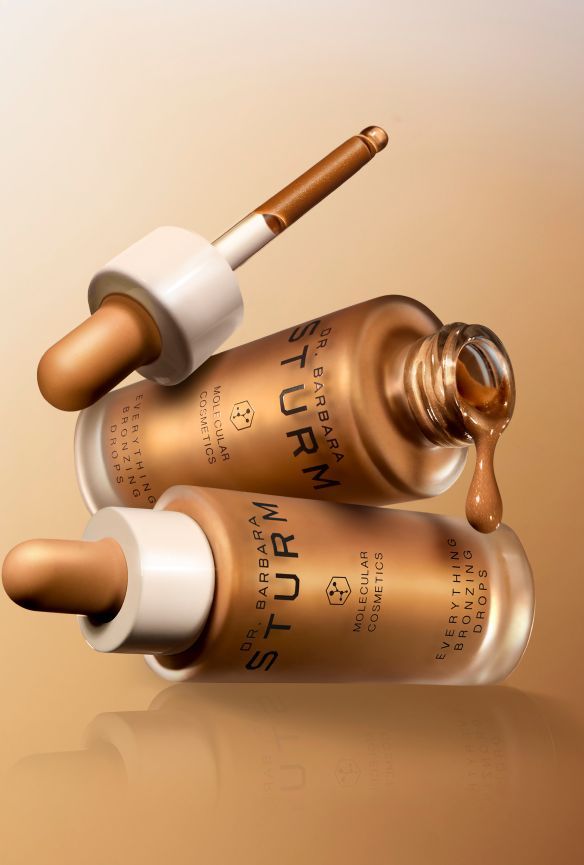 Two beauty serum bottles with droppers on a gradient background.