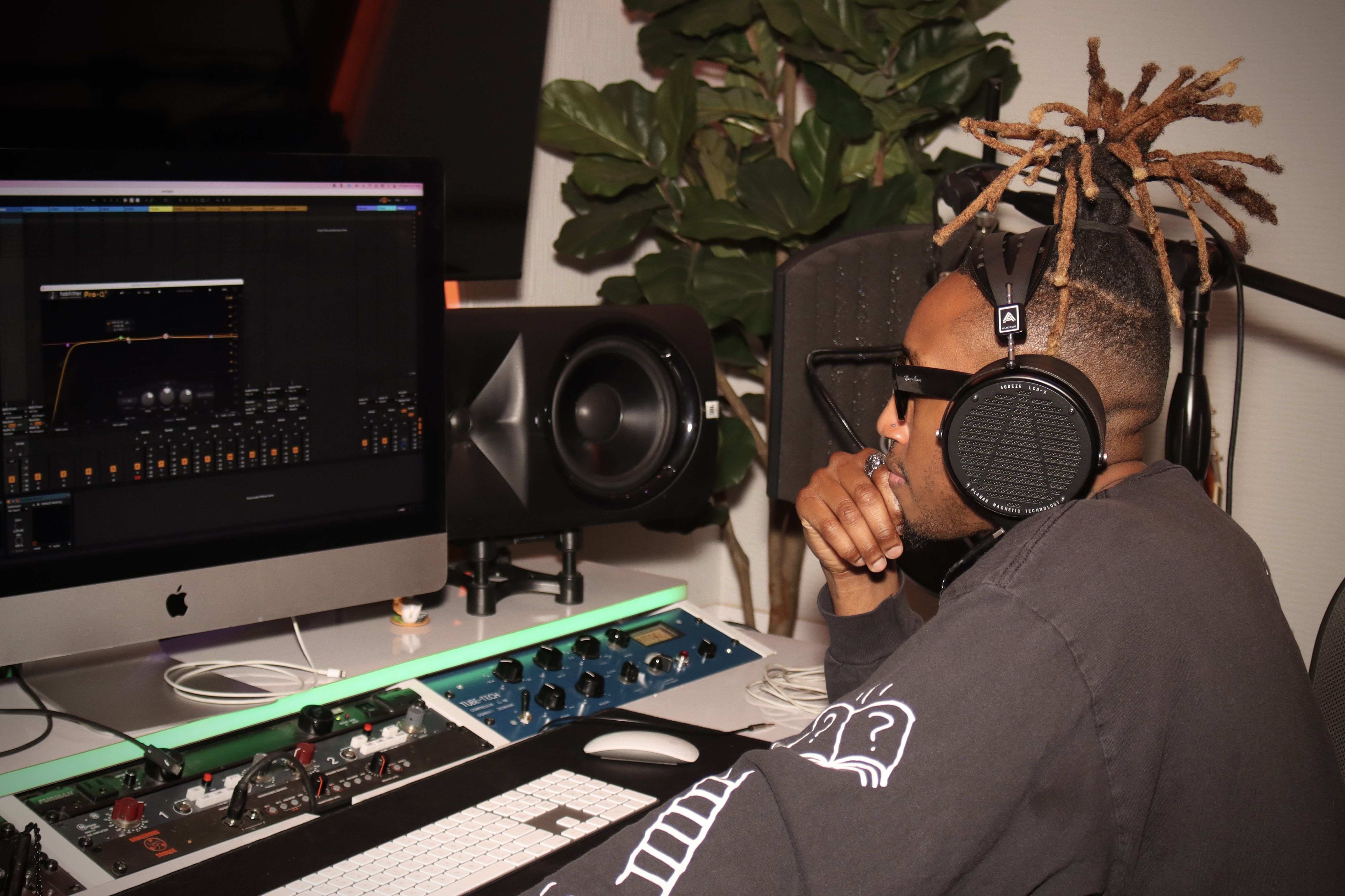 Renzo wearing Audeze LCD-X headphones mixing on Mac in the studio 