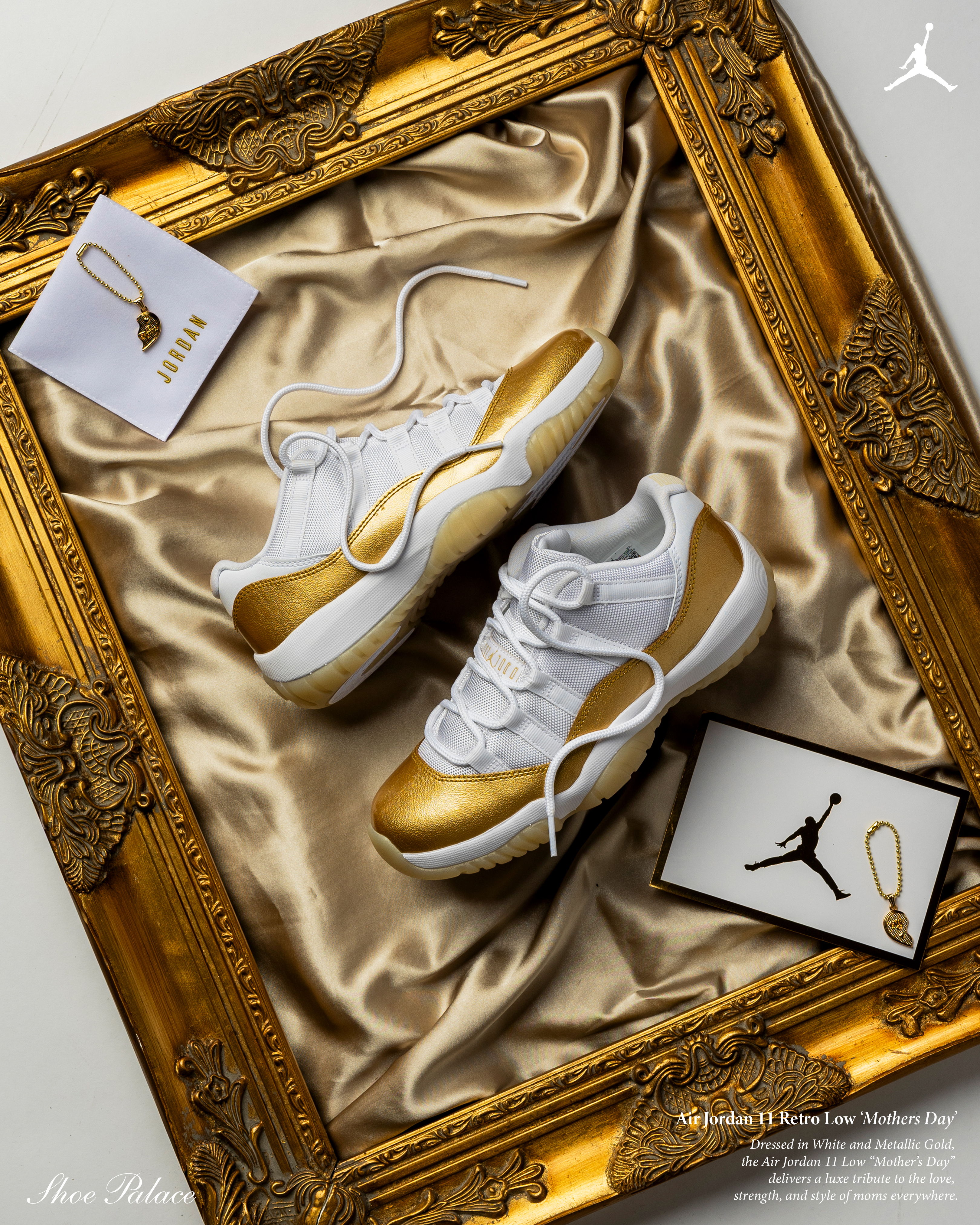 White and gold sneakers displayed in a golden frame on satin fabric.