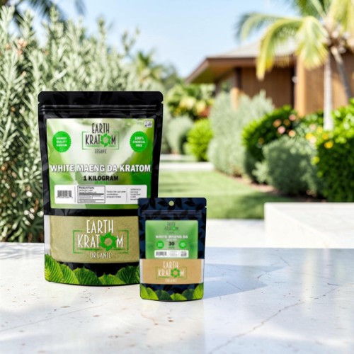 Product packaging on a table in a garden setting.