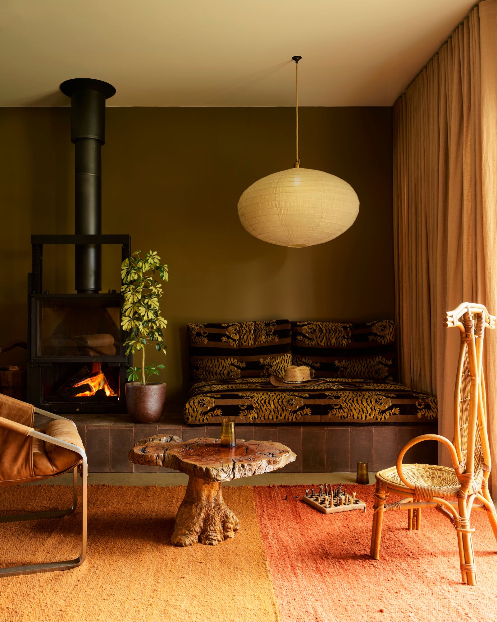 Cozy living room with a fireplace, seating, and a pendant light.
