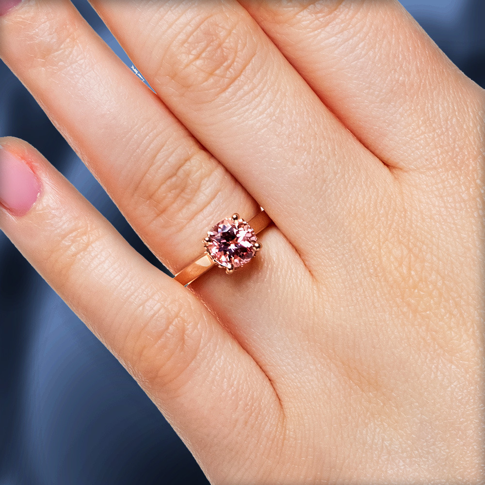 Beautiful hidden diamond halo engagement ring in rose gold with 2ct lab pink sapphire center stone worn on hand