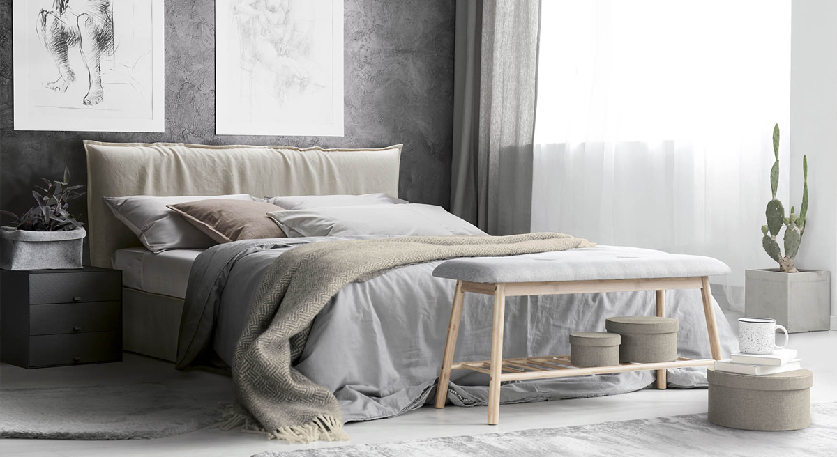 Modern Milano bedroom interior with a bed, artwork, and plants.
