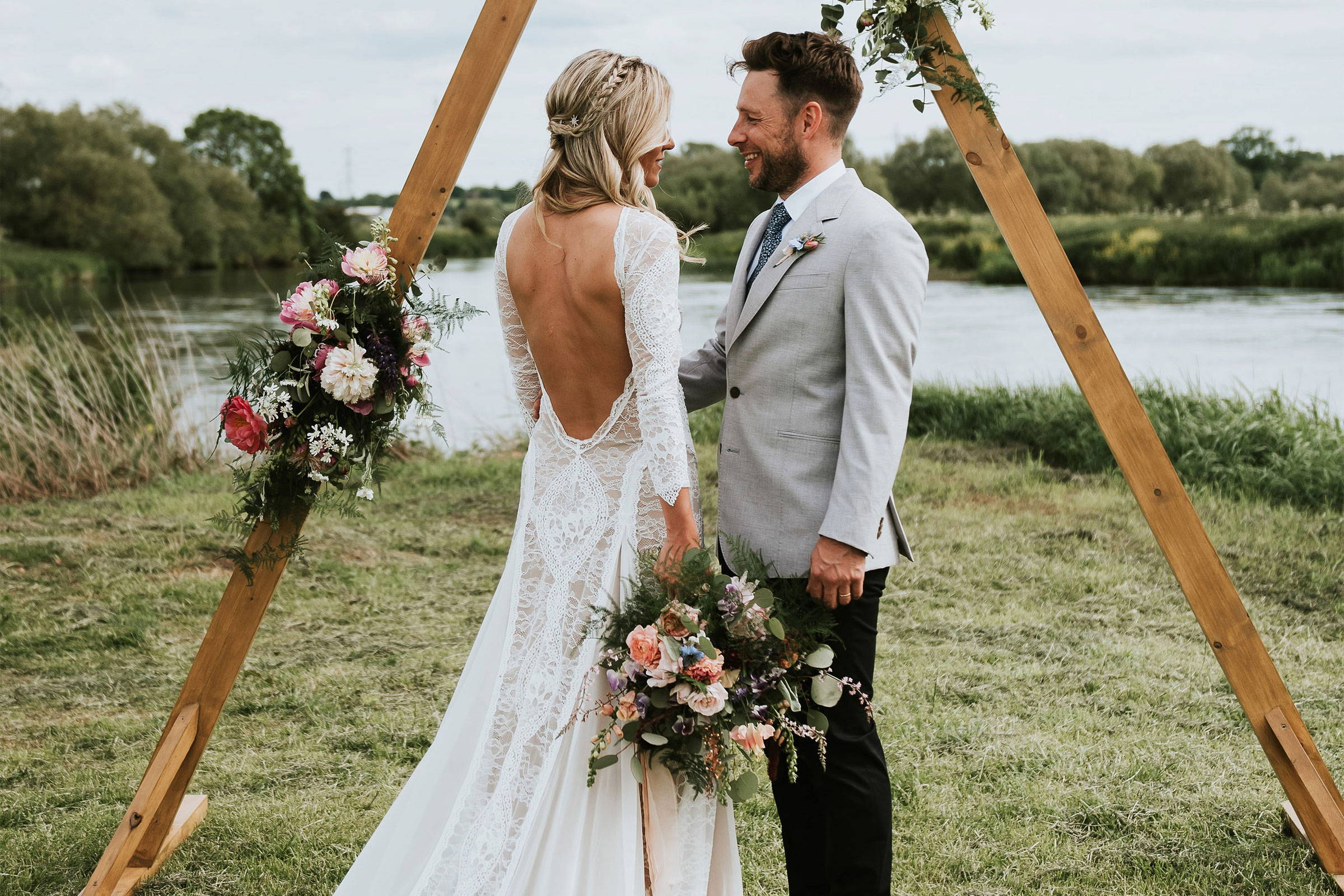 Grace bride in the Inca gown  underneath a triangle arch