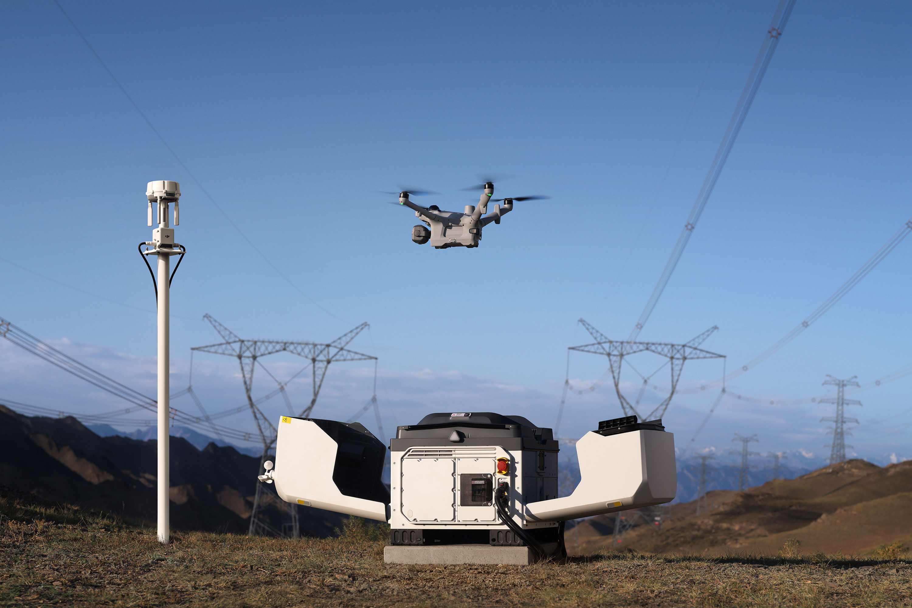A DJI Matrice 5TD launching from a DJI Dock 4 near power lines.