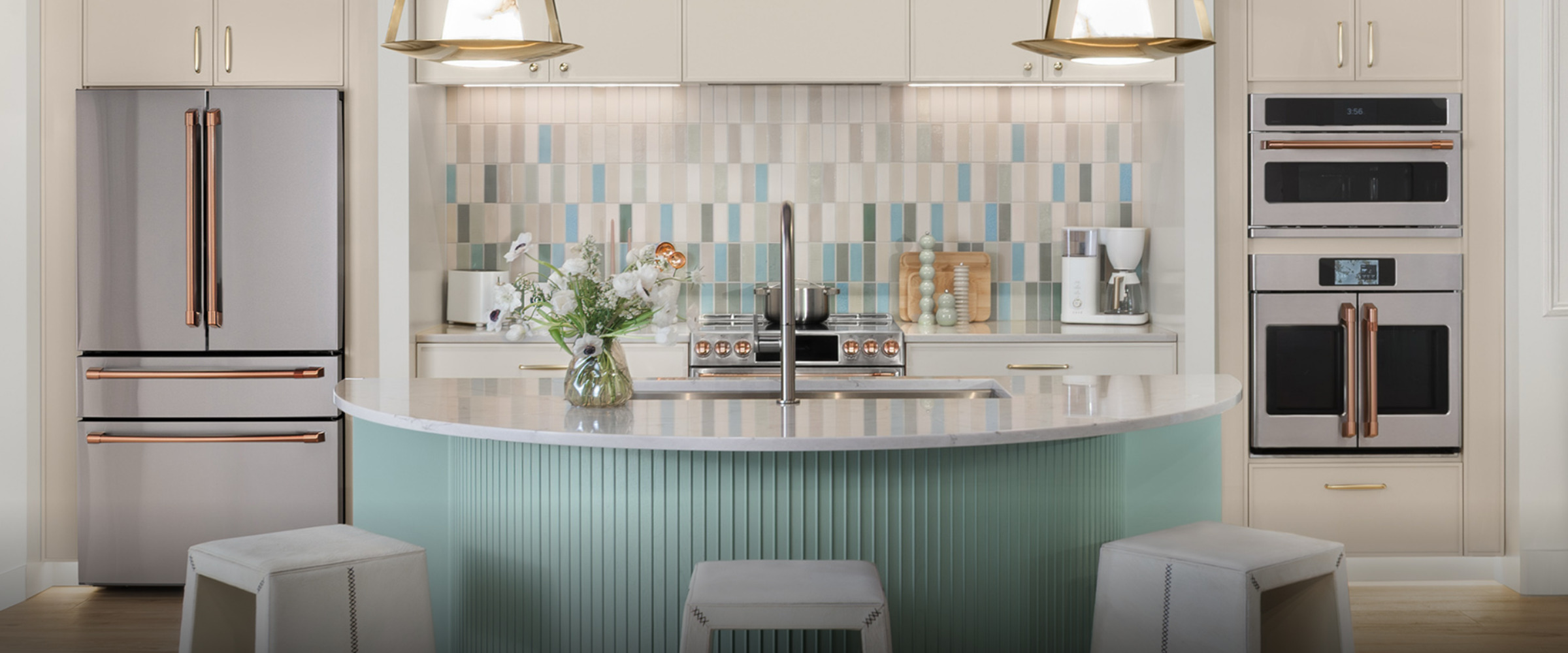 Modern kitchen with island, stylish decor, and stainless steel appliances.