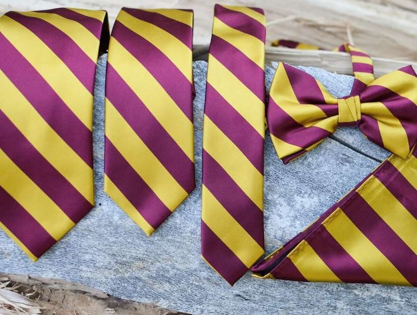 A variety of maroon and gold striped ties