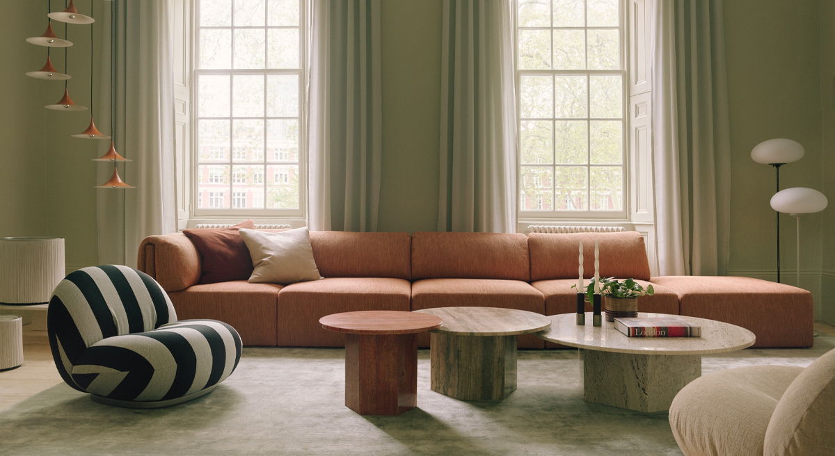 Cozy living room with a sofa, coffee table, and dining area.