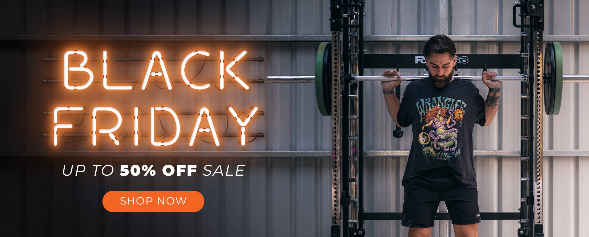 Black Friday Up to 50% OFF Sale ON NOW. Man in garage gym working out on all-in-one trainer. 