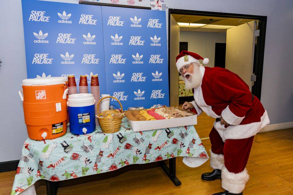 sp x adidas christmas party santa posing with food table