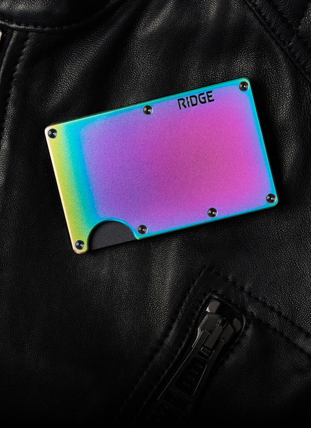A colorful Ridge wallet on a black leather surface.