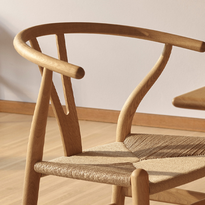 Wooden chair with a curved back and woven seat.