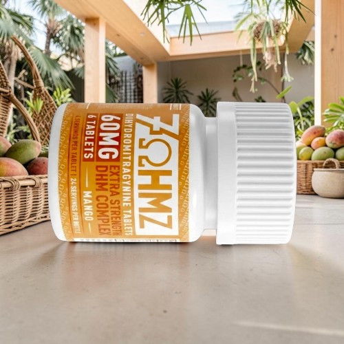 Bottle of 60mg gummies on a table with tropical plants in background.