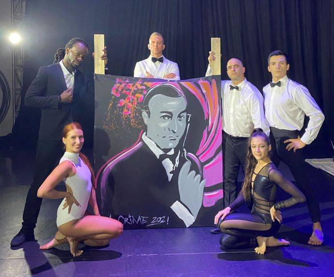 James Bond Painting being held by dancers