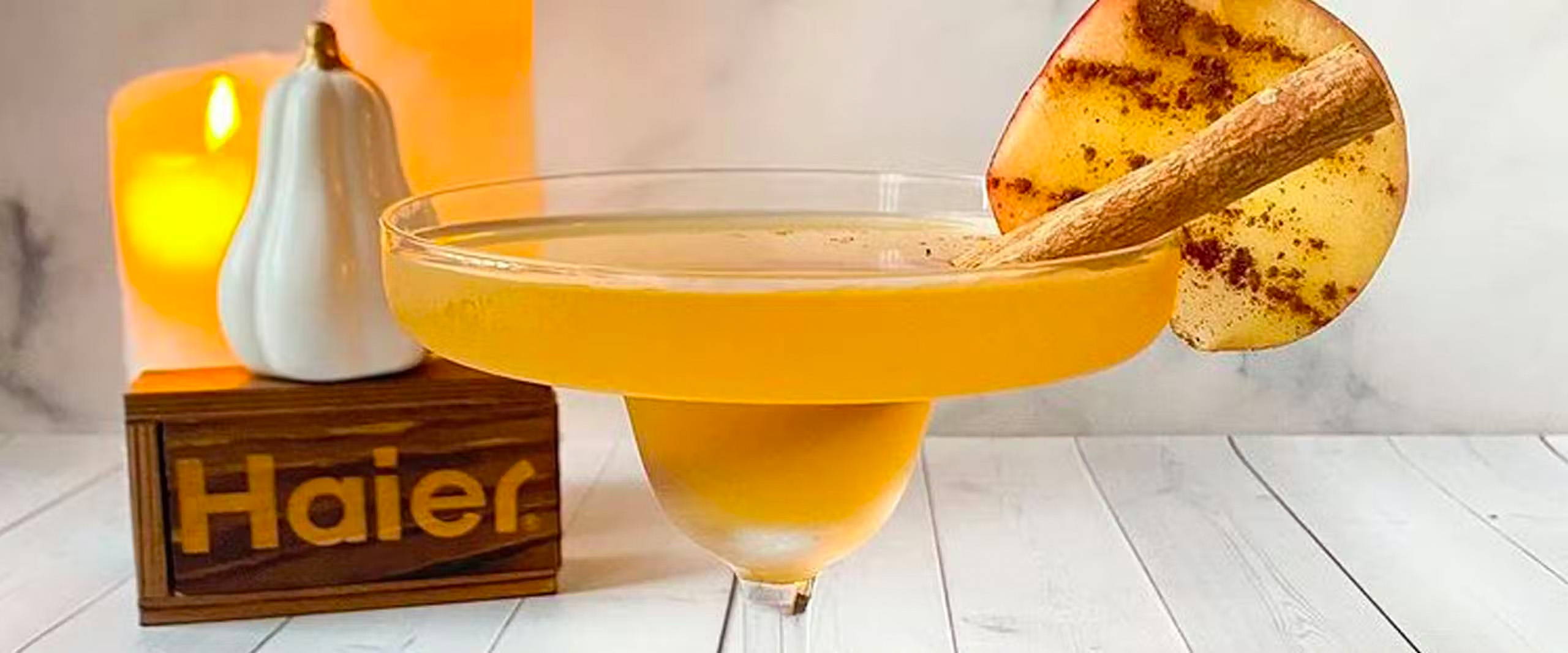 A glass of apple cider mezcal margarita with garnish.