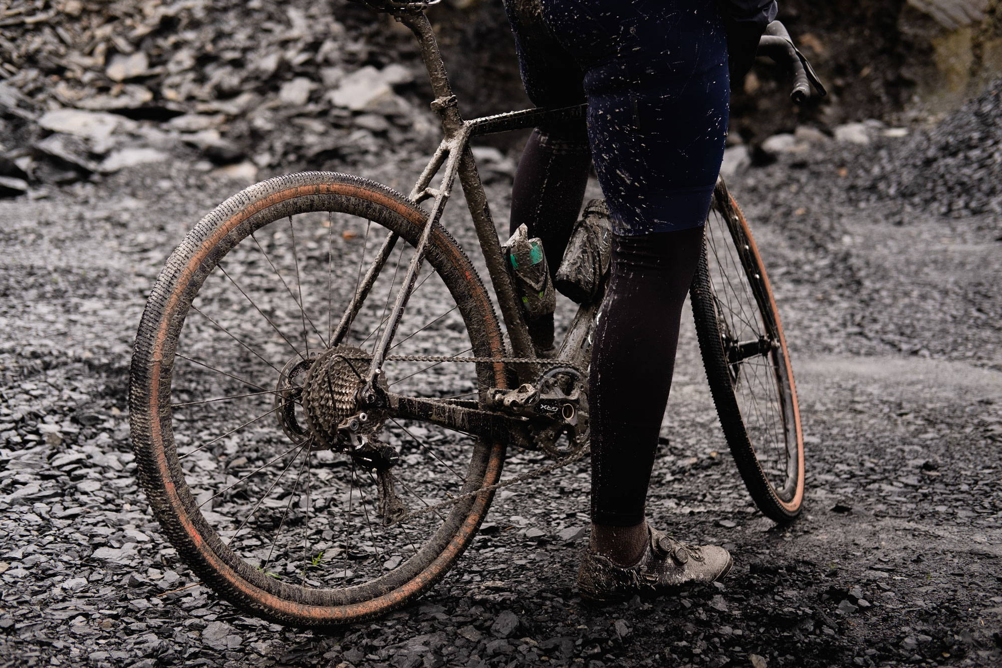 Muddy gravel bike and cyclist