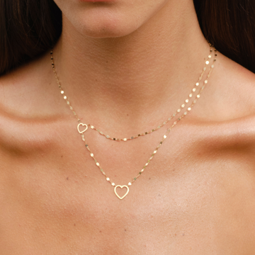 Gold heart pendant necklace with two chains.