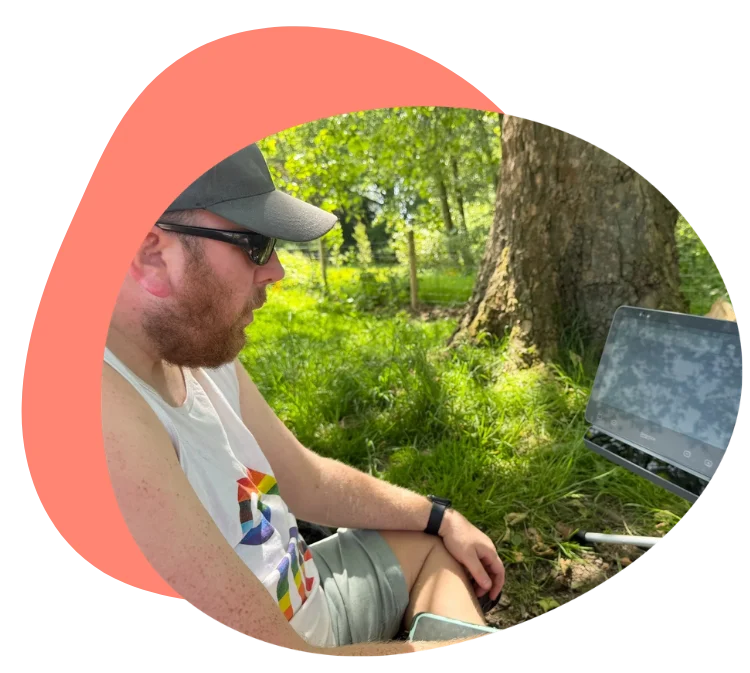 Man using his Grid Pad communication device outdoors.