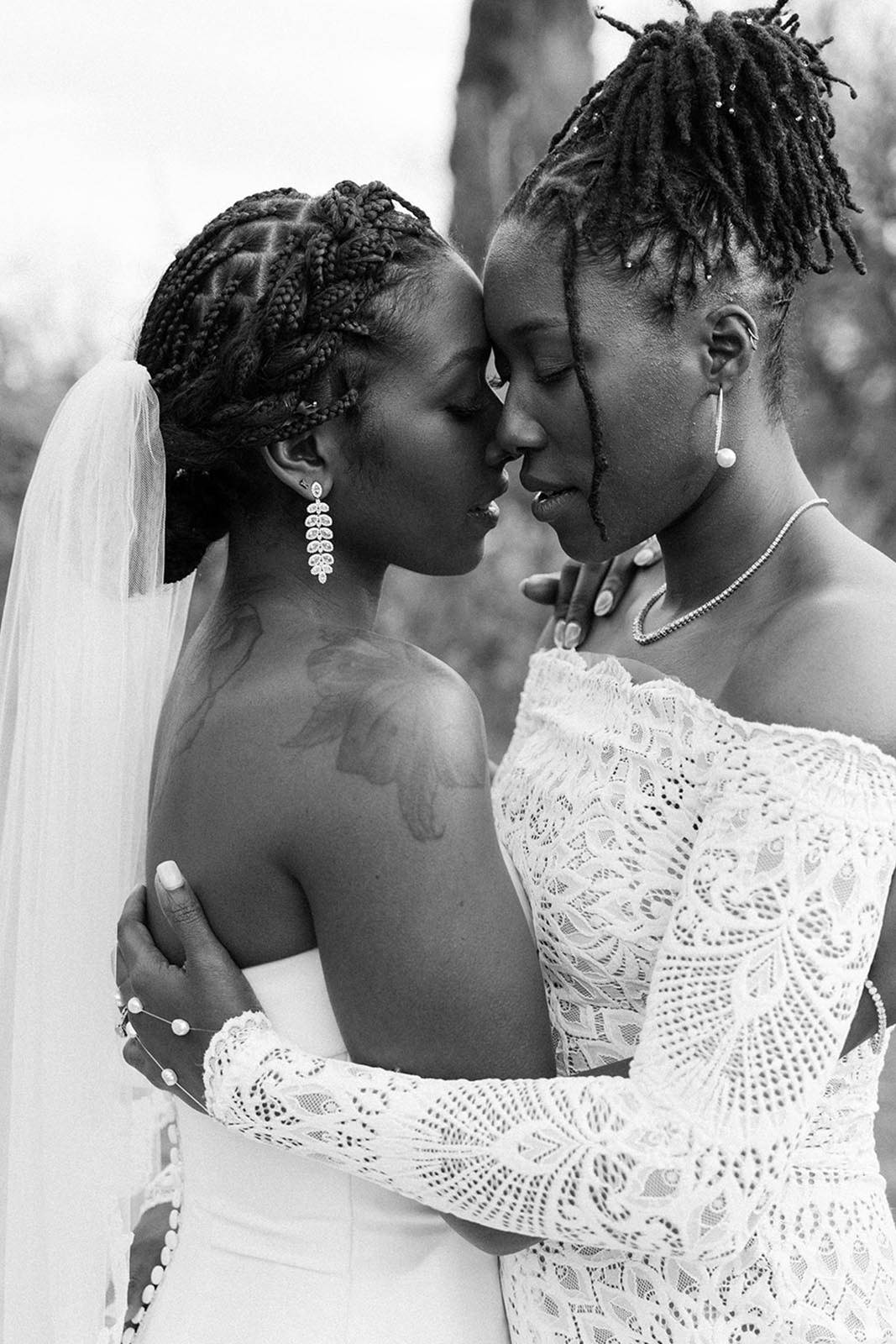Two brides, holding each other