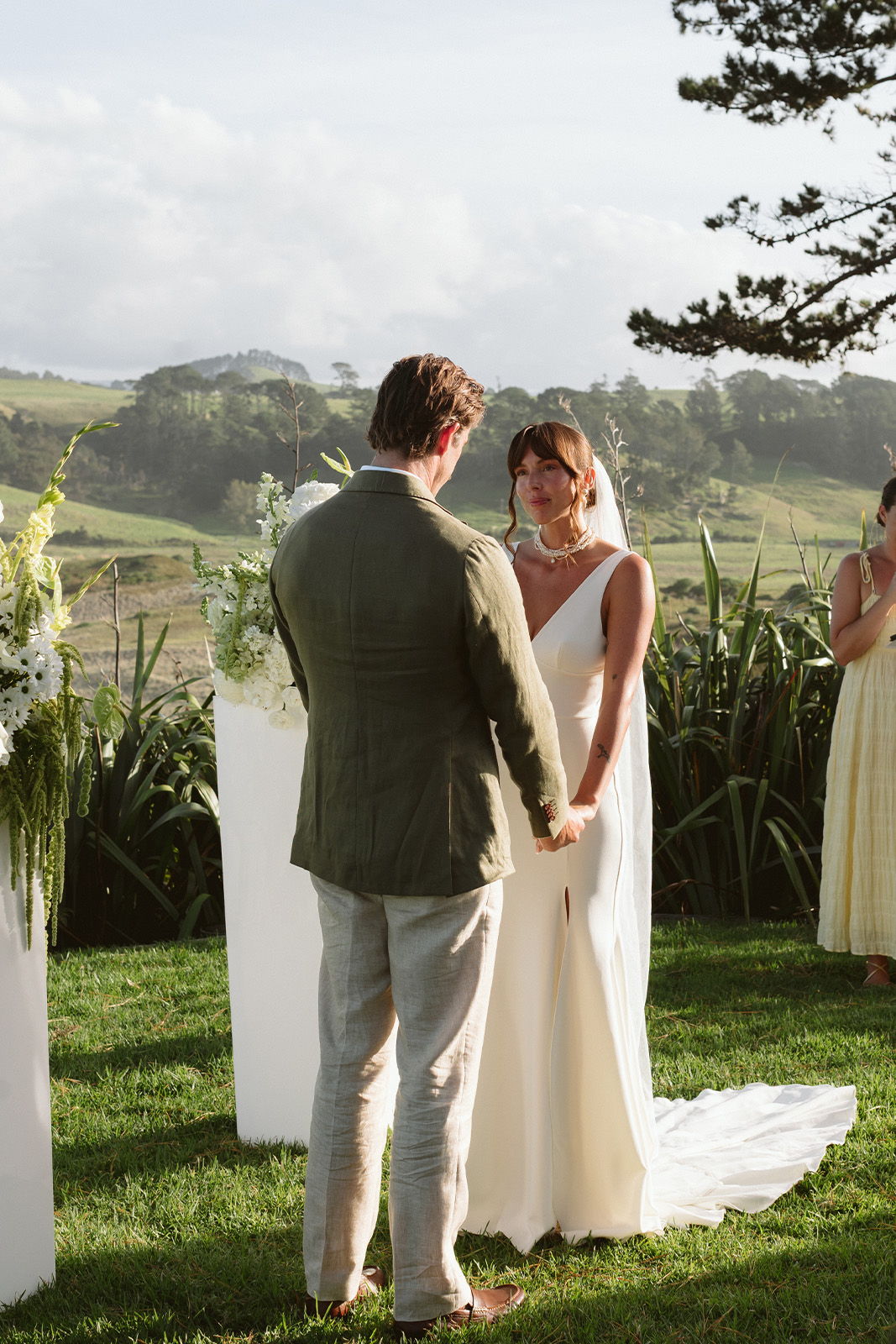 A couple exchanging vows during an outdoor wedding ceremony.