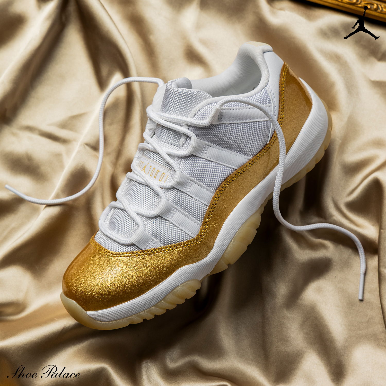 A gold and white sneaker on a satin background.