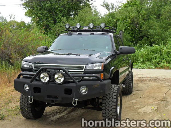 Front three-quarter view of Dean's black lifted 2005 Chevrolet Silverado 2500 HD with off-road bumper and roof lights, install photo 1