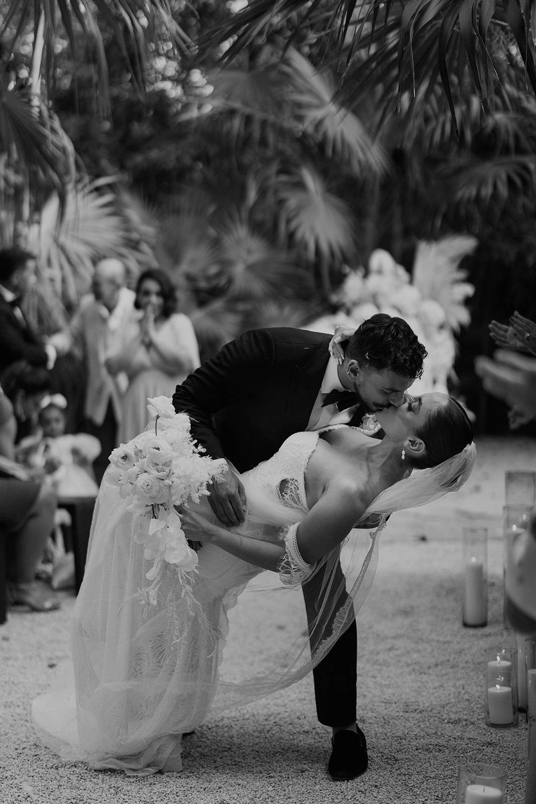 The bride and groom sharing a dip kiss