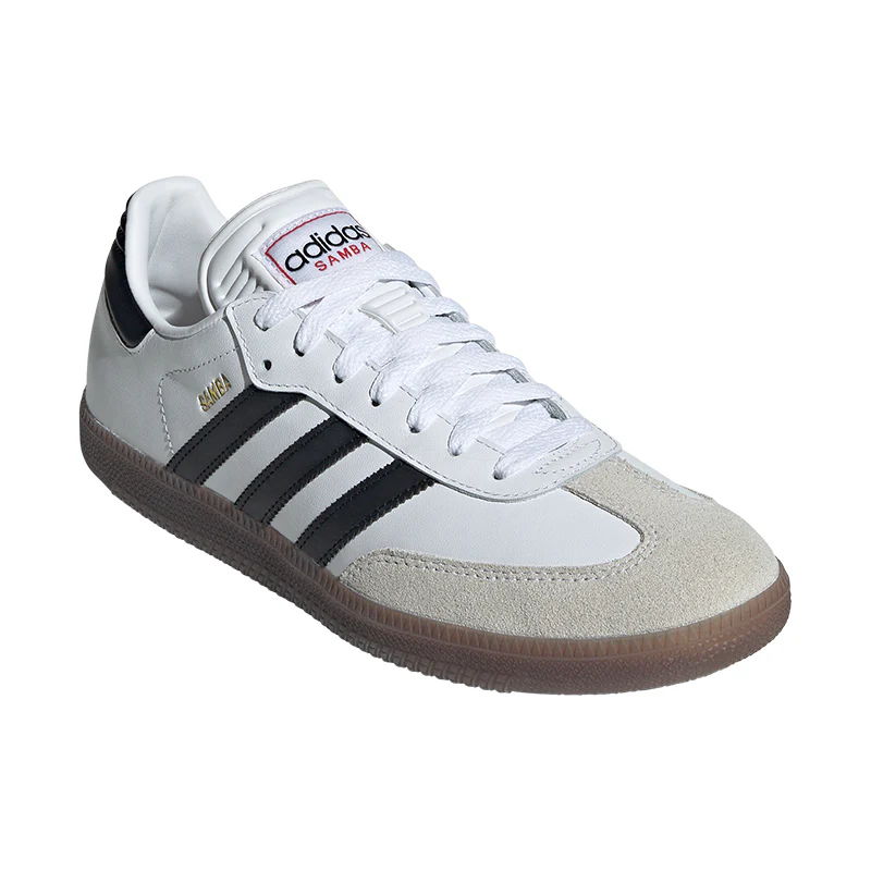White and gray Adidas sneakers with black stripes and a gum sole.
