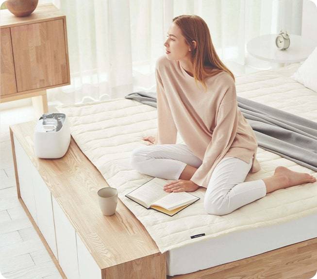 Lifestyle image of woman with Brookstone appliances