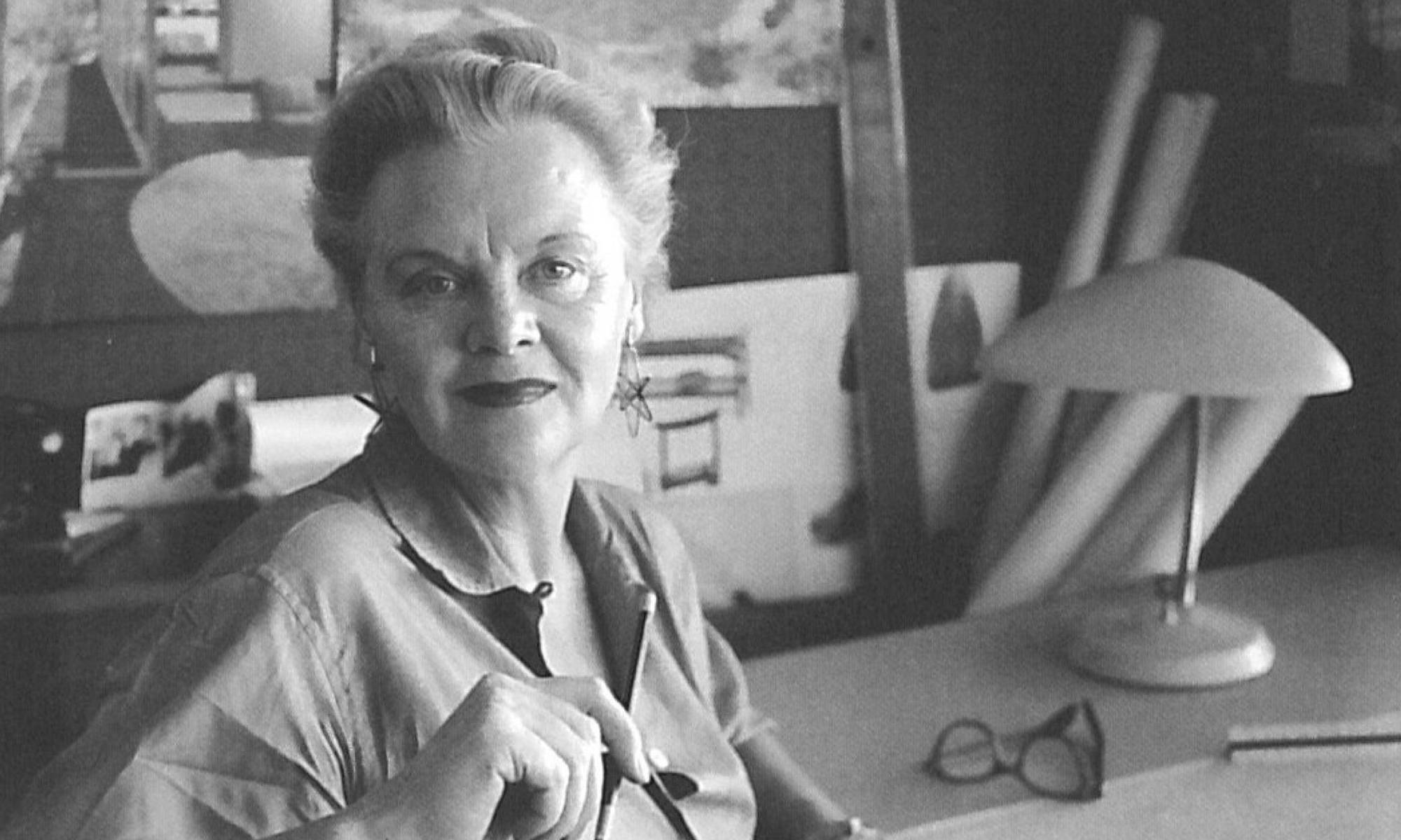 Greta in her California studio with mid century modern lamp on desk