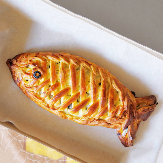 a British fish pie shaped as a fish with an olive eye