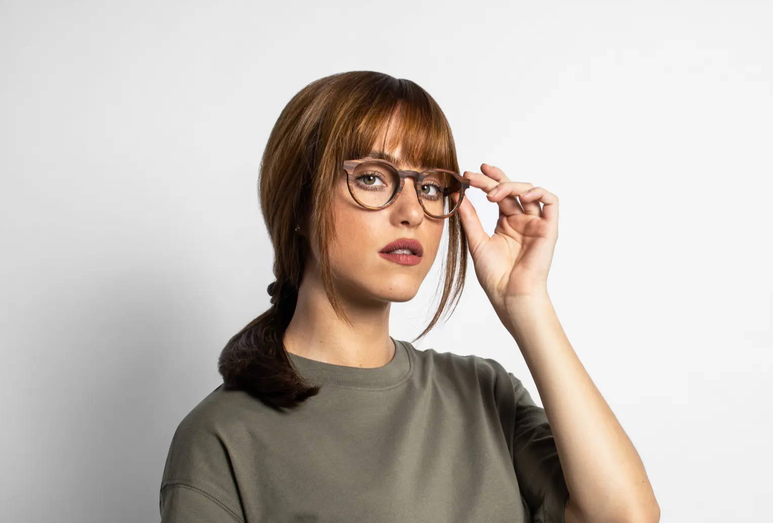 Woman wearing wood eyeglasses frames