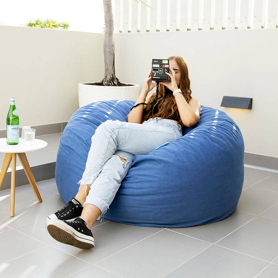 Girl relaxing in giant blue bean bag
