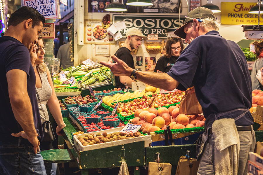 farmer and customer talking at a farmers market