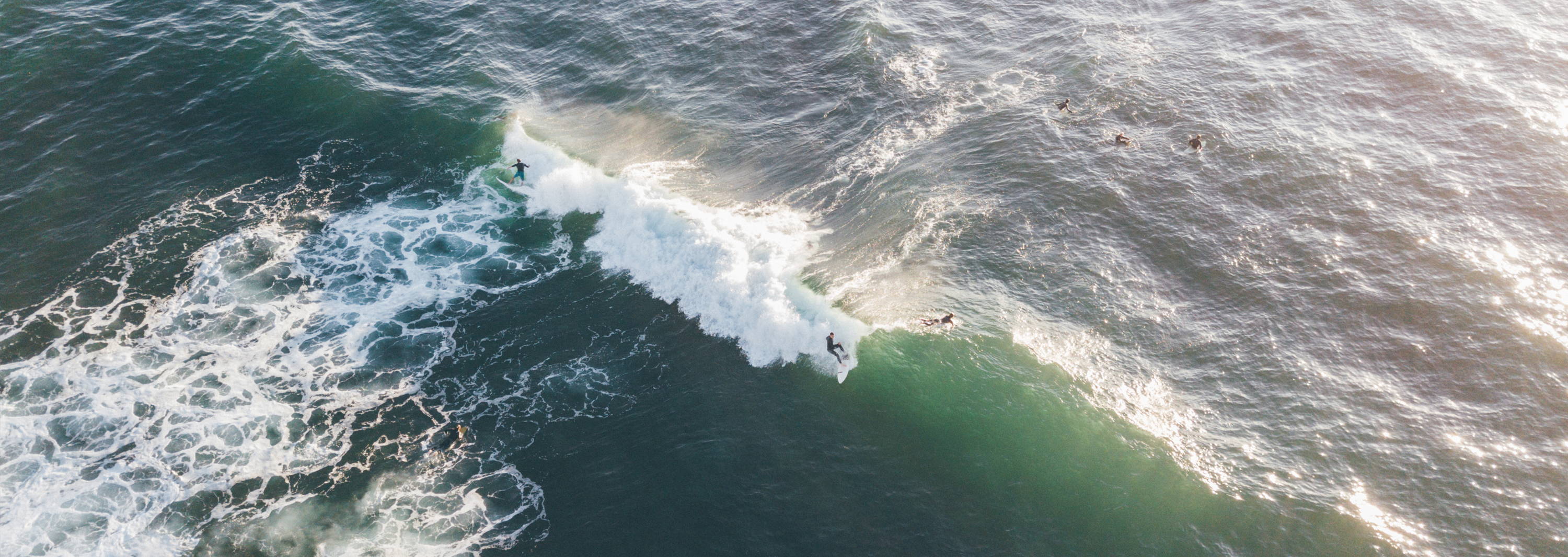 Arial drone view of surfers surfing windandsea in La Jolla, San Diego, California.