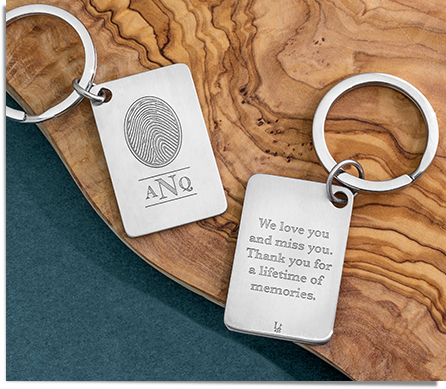 stainless steel keychain engraved with a fingerprint, monogram, and inscription