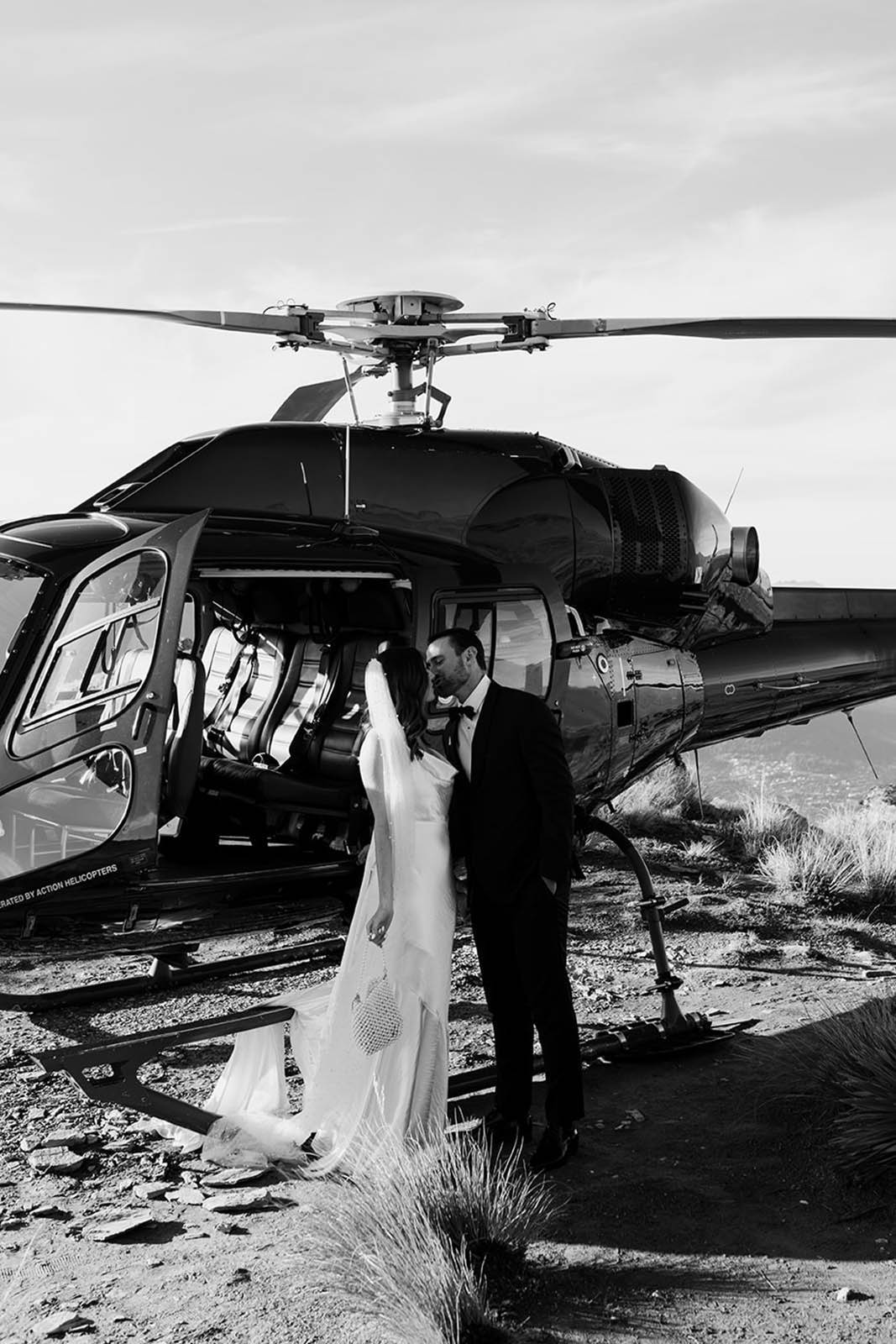 Bride and groom, standing outside of the helicopter