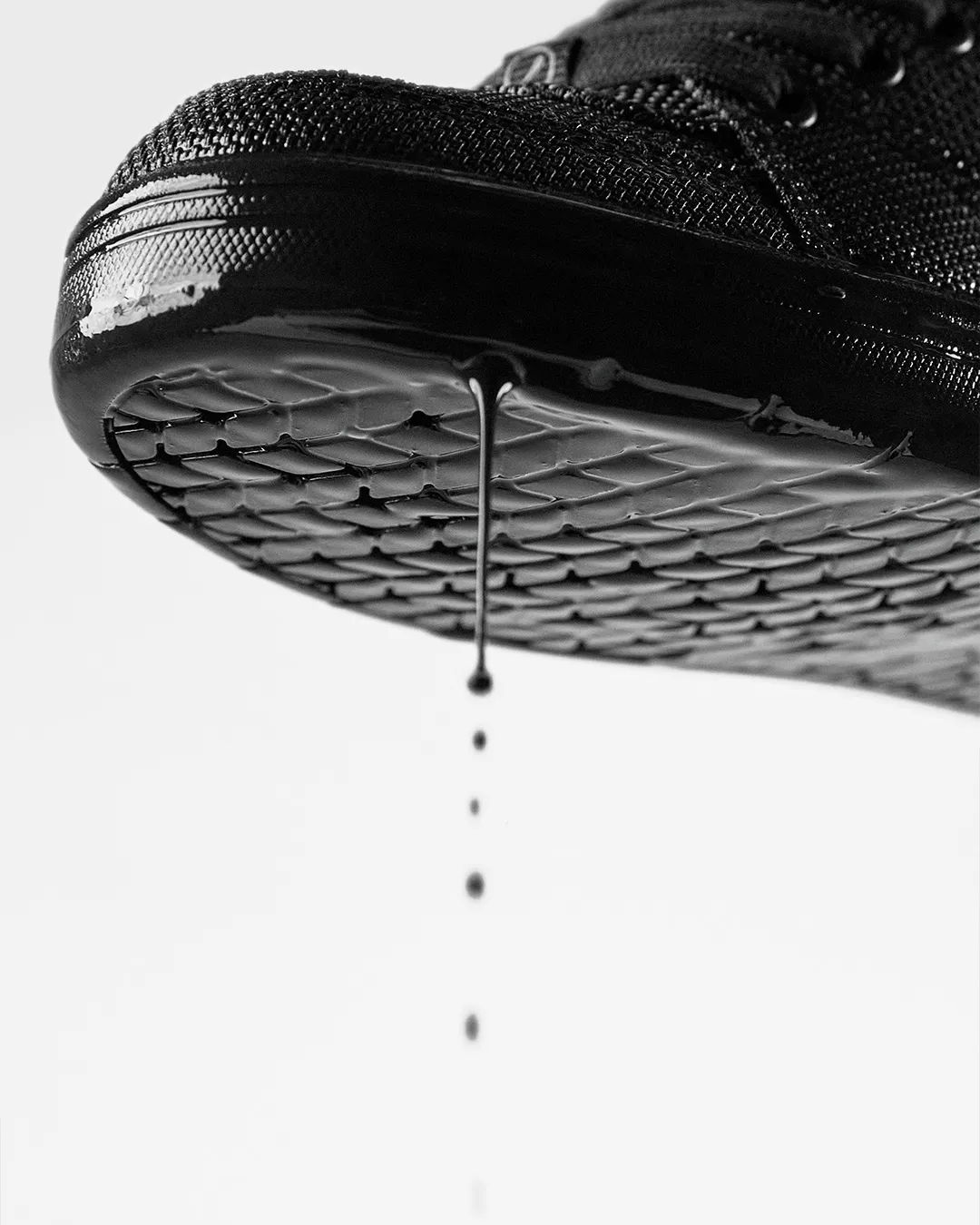 Close-up of a shoe sole dripping water.