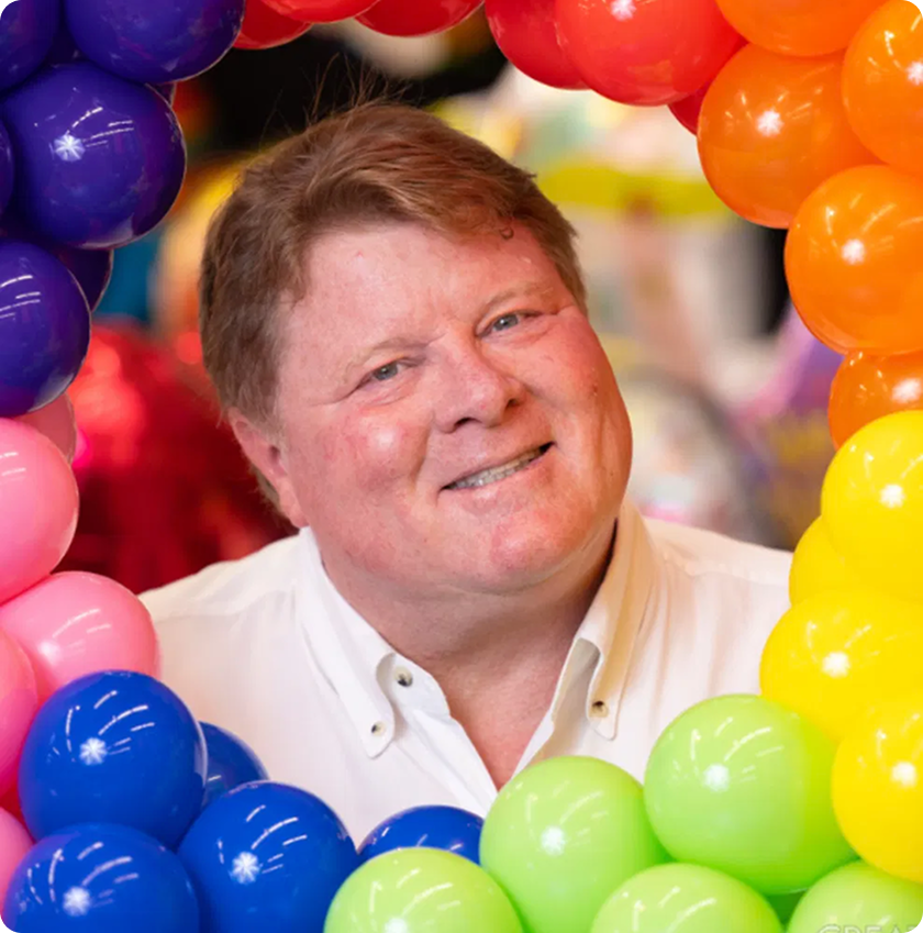 Diddams founder surrounded by colorful balloons