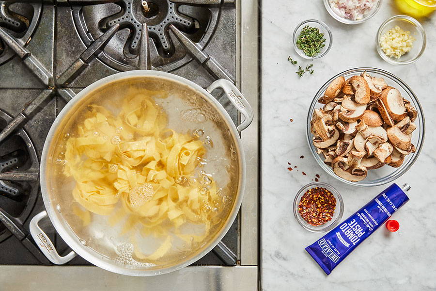 Pappardelle pasta cooking on stove