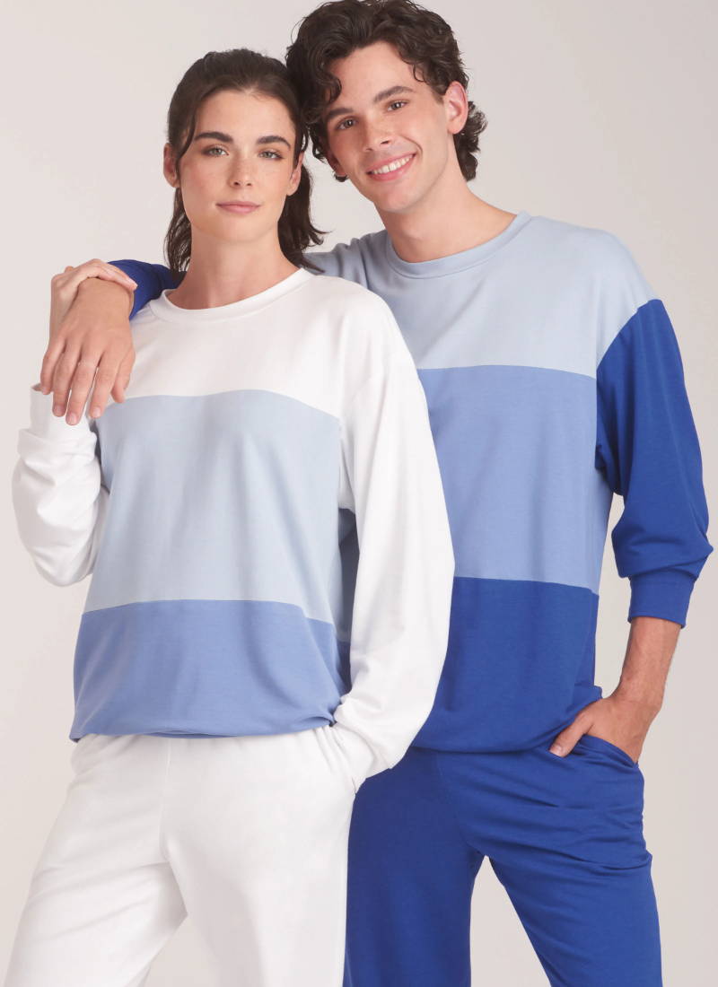 Two models wearing matching color-blocked sweatshirts and pants.